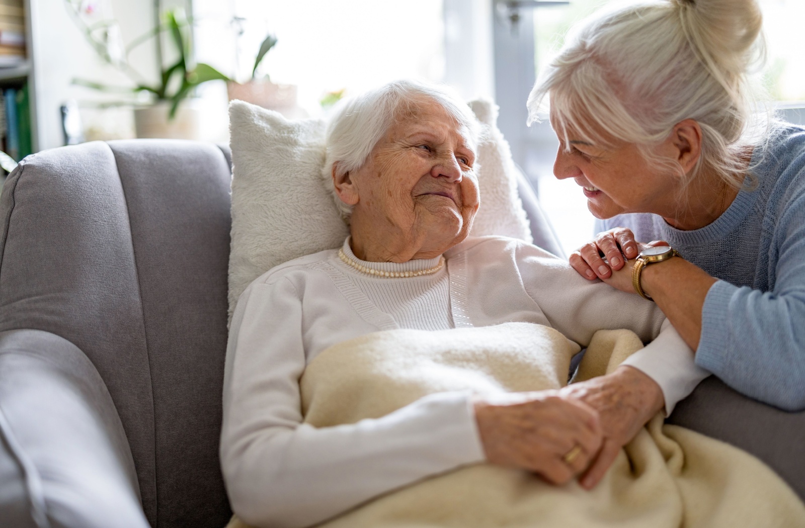 A family member caring for their mature parent in the comfort of their home.